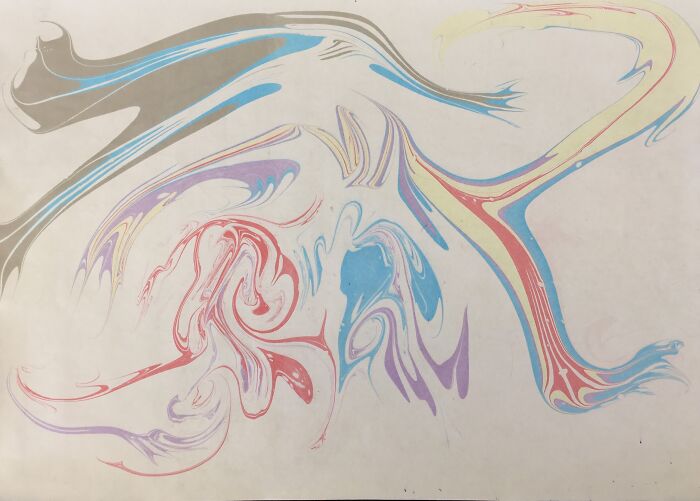 Traditional marbling art with vibrant swirling colors, resembling flowing tattoo designs. Traditional marbling art with vibrant swirling colors, resembling flowing tattoo designs.