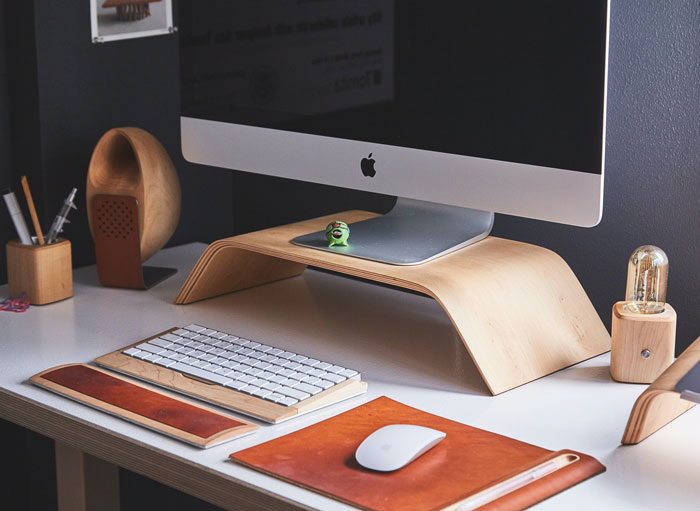 Home office setup with a computer and accessories on a desk, ideal for avoiding boredom indoors.
