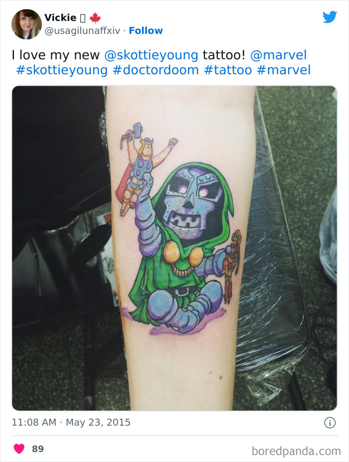 Marvel tattoo of Doctor Doom with Thor doll on forearm, showcasing comic art style and colorful design.