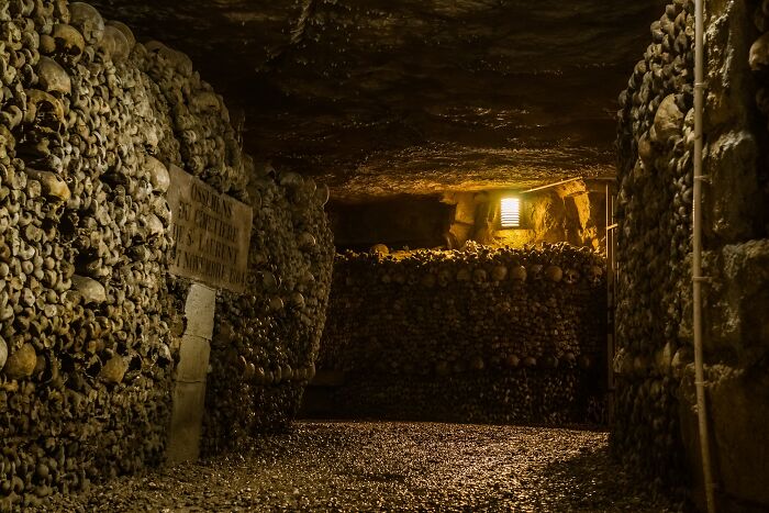 The Catacombs Of Paris with Many skulls in the walls