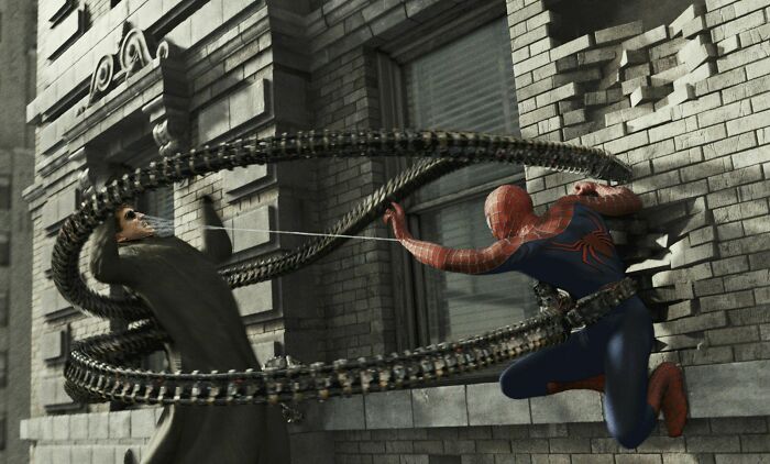 In Spider-Man 2 (2002), Dr. Otto Octavius Was An Ordinary Man Who Had Four Mechanical Arms Fused Into His Spine. This Apparently Explains How He Can Shrug Off Multiple Punches To The Face From A Guy Who Can Stop A Train With His Bare Hands