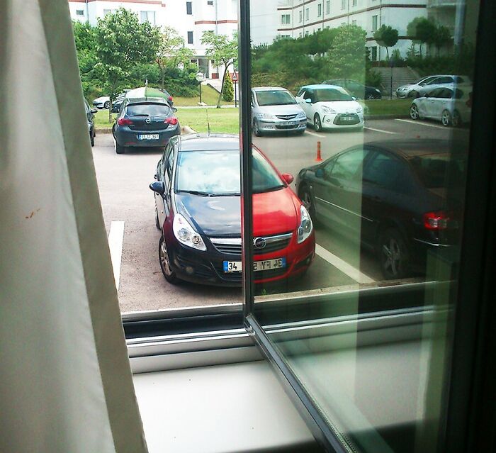 The Reflection Of An Identical Car From Window Perfectly Matches