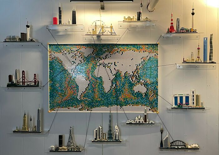 Intricate LEGO builds of world landmarks surrounding a detailed LEGO world map display as incredible works of art.