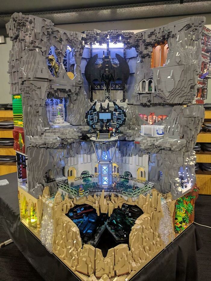 Detailed incredible LEGO build showcasing a multi-level Batcave scene with vehicles and intricate rock formations.