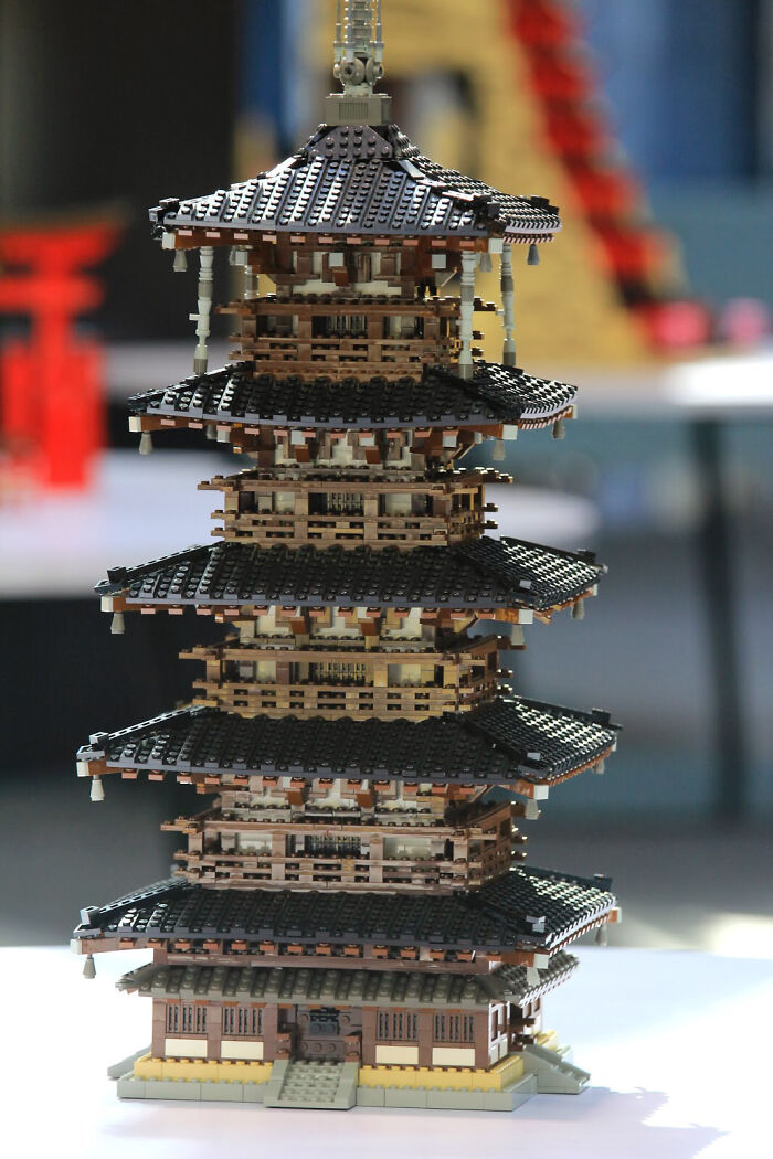Intricate LEGO builds showcasing a multi-tiered pagoda structure, highlighting incredible details in this unique LEGO art piece.