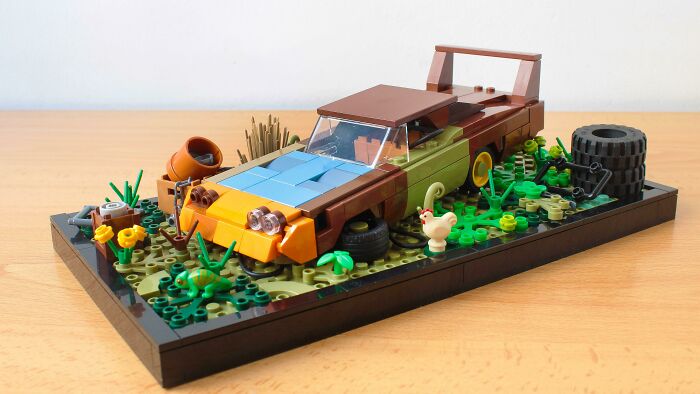 LEGO builds of a detailed vintage car and garden scene with flowers, tires, and small animal figures on a display base.