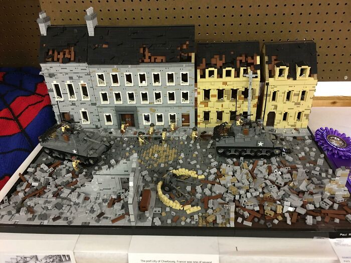 Intricate LEGO builds depicting wartime urban scene with detailed buildings, soldiers, tanks, and rubble as a real work of art.