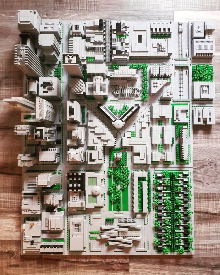 Detailed LEGO cityscape build with intricate architecture and green landscaping, showcasing incredible LEGO builds as works of art.