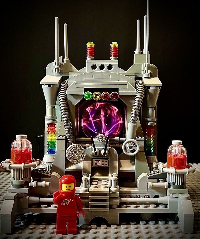 Intricate LEGO builds featuring a space-themed machine with glowing center and a classic LEGO astronaut figure in red suit.