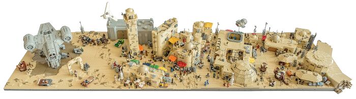Large detailed LEGO builds depicting a desert battle scene with spacecraft and numerous miniature figures as works of art.