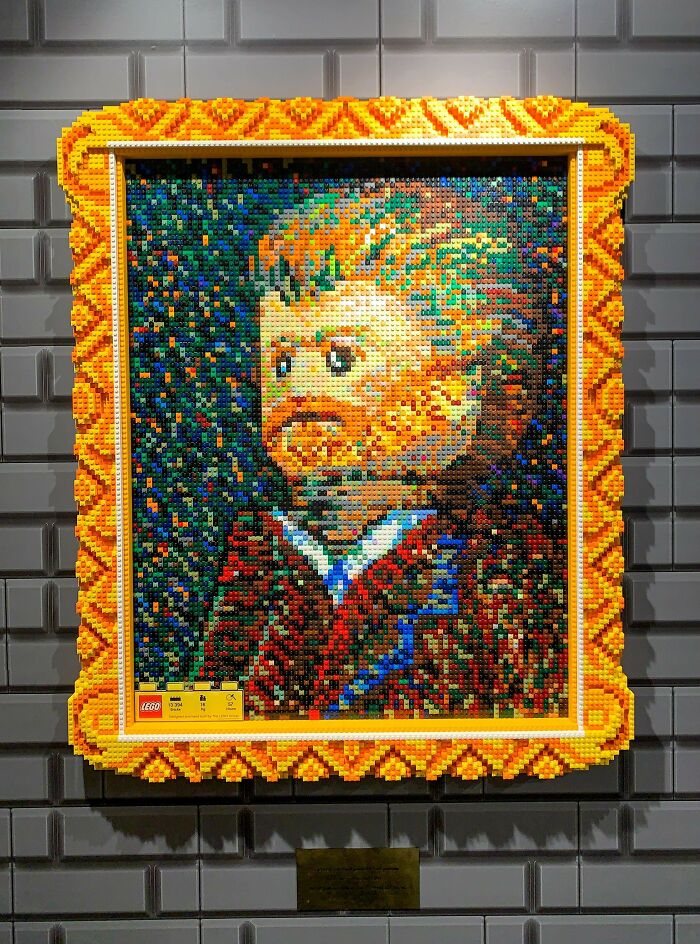 Pixelated portrait made of LEGO bricks with an intricate orange frame showcasing incredible LEGO builds as art.
