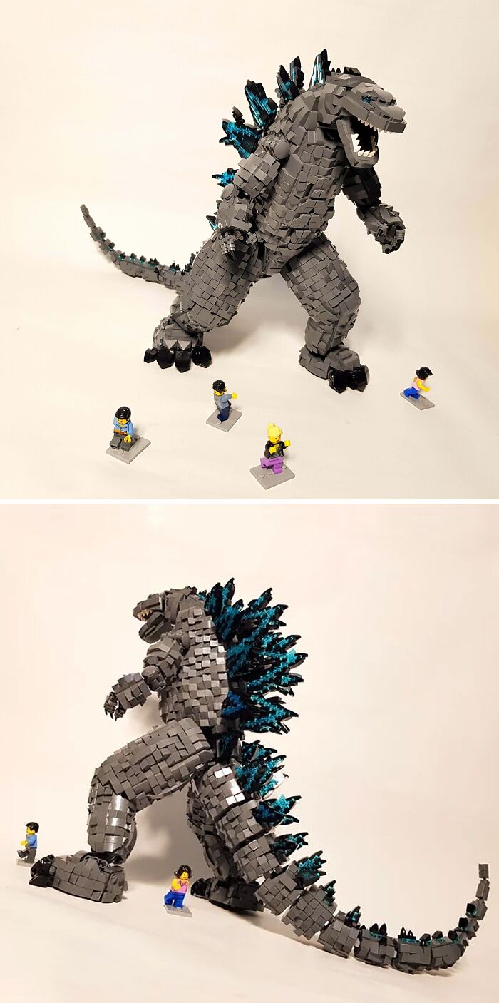 Large detailed LEGO build of Godzilla with blue spikes, accompanied by several small LEGO figures on a plain background.