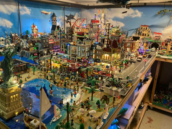 Intricate LEGO builds depicting a vibrant coastal city scene with detailed buildings, vehicles, and mini figures on display.