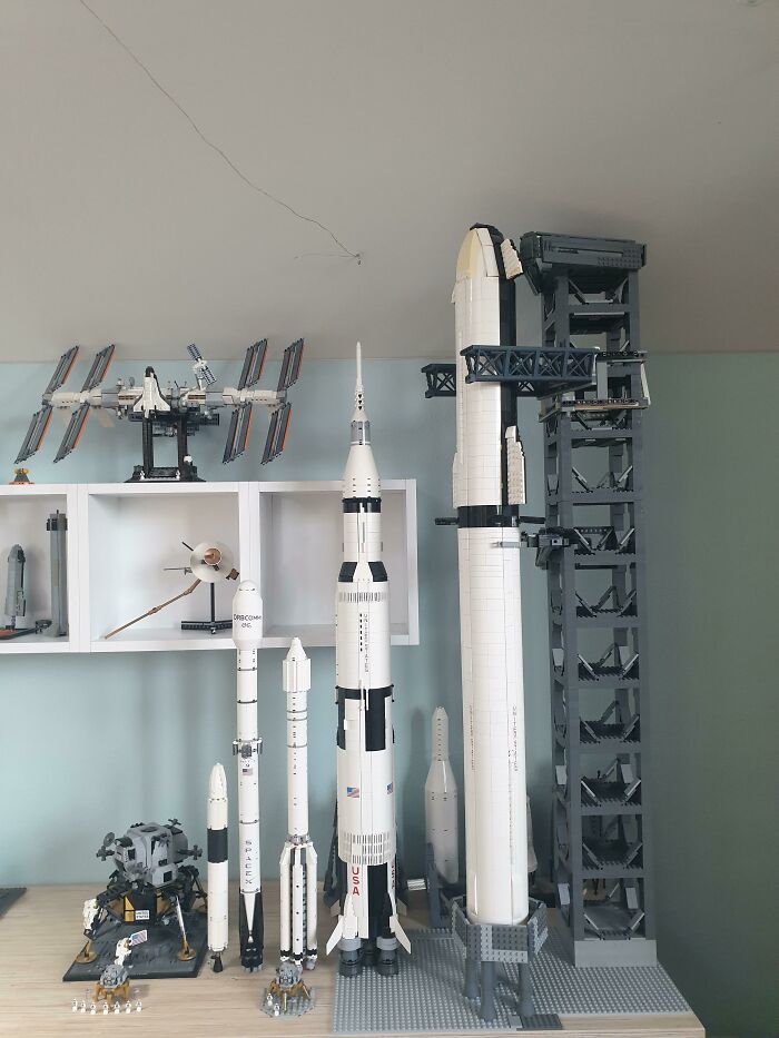 Detailed LEGO builds of spacecraft and rockets arranged on a shelf showcasing incredible LEGO builds as real works of art