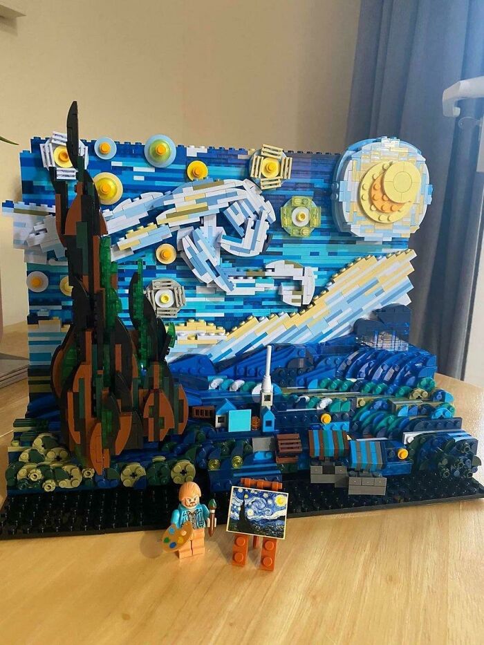 LEGO build recreating Starry Night painting with blue, yellow, and green bricks and a mini artist figure holding a brush and palette.