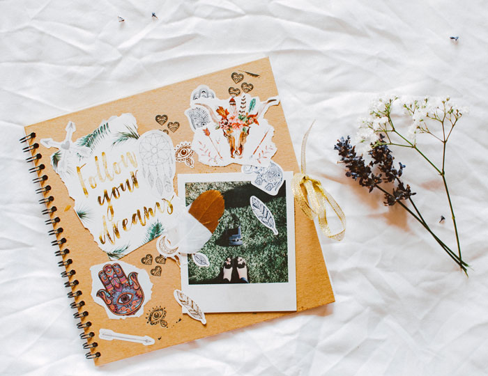 Scrapbooking materials, including stickers and a photo, laid out creatively on a white surface to inspire fun things to do.