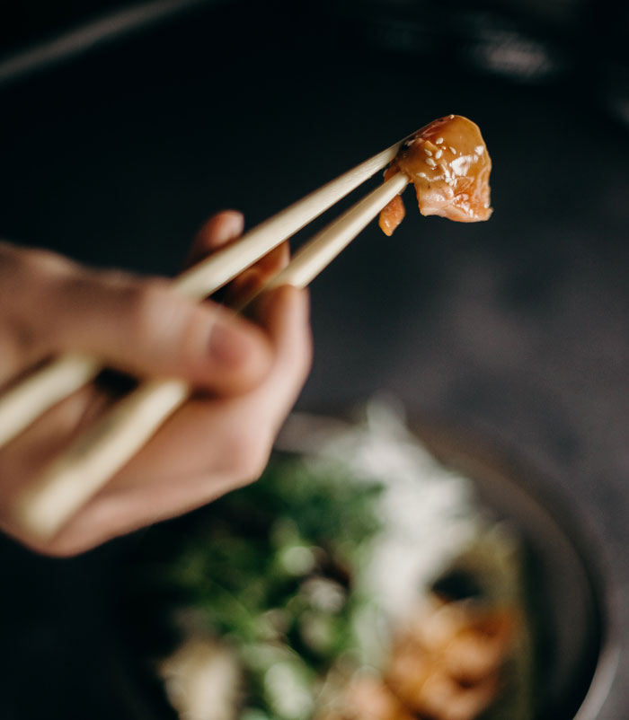 Using chopsticks to pick up food is a fun thing to do at home to avoid boredom.