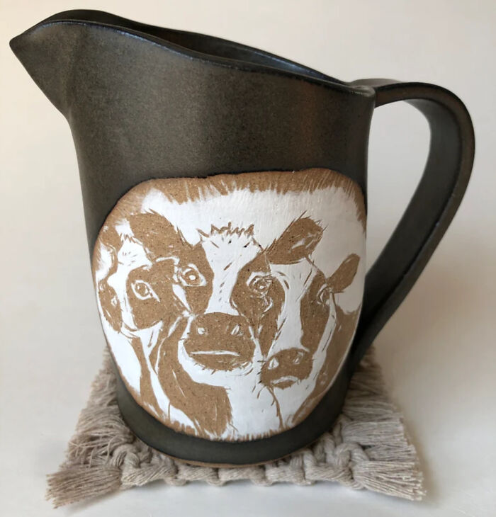 A Herd Of Cows Gaze Out Curiously, Or Perhaps, Indignantly, Awaiting Their Dinner