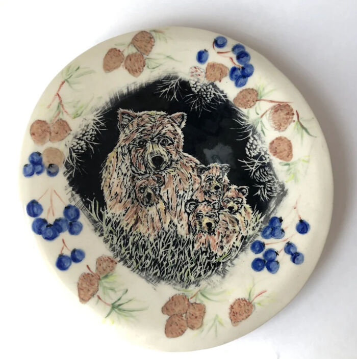 A Bear Family Peer Out From Their Hidden Den, Behind The Pines And Berry Bushes