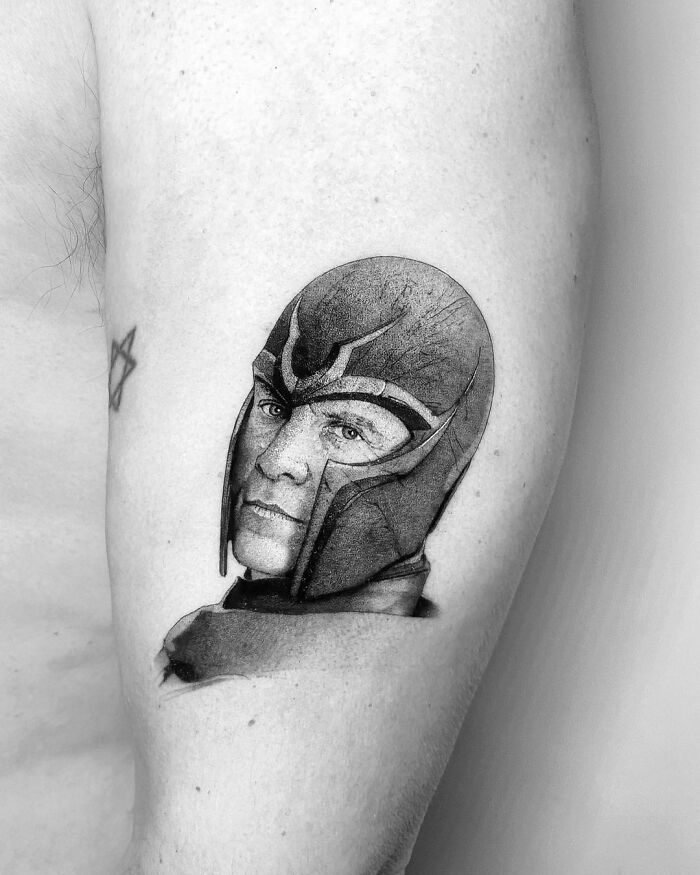 Marvel tattoo of a character Magneto with a helmet, detailed black and gray ink.