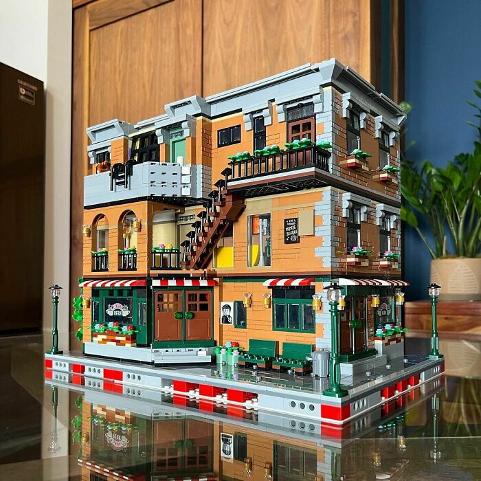 Detailed LEGO build of a multi-story building with balconies, stairs, and street lamps showcasing incredible LEGO art.