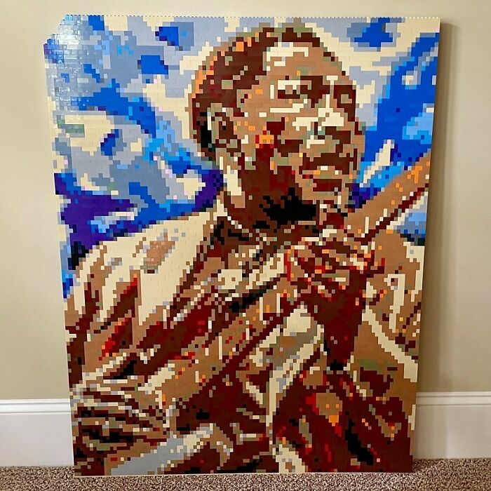 LEGO mosaic art of a smiling man playing a guitar with a vibrant blue sky background, showcasing incredible LEGO builds.