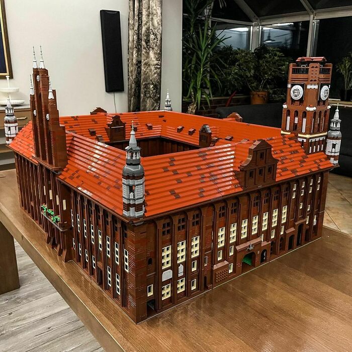 Detailed LEGO architectural build with red roof and clock tower, showcasing one of the incredible LEGO builds as real works of art.