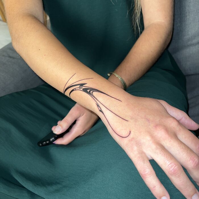 Arm adorned with a flowing tattoo design inspired by traditional Sernakkab marbling art. Arm adorned with a flowing tattoo design inspired by traditional Sernakkab marbling art.