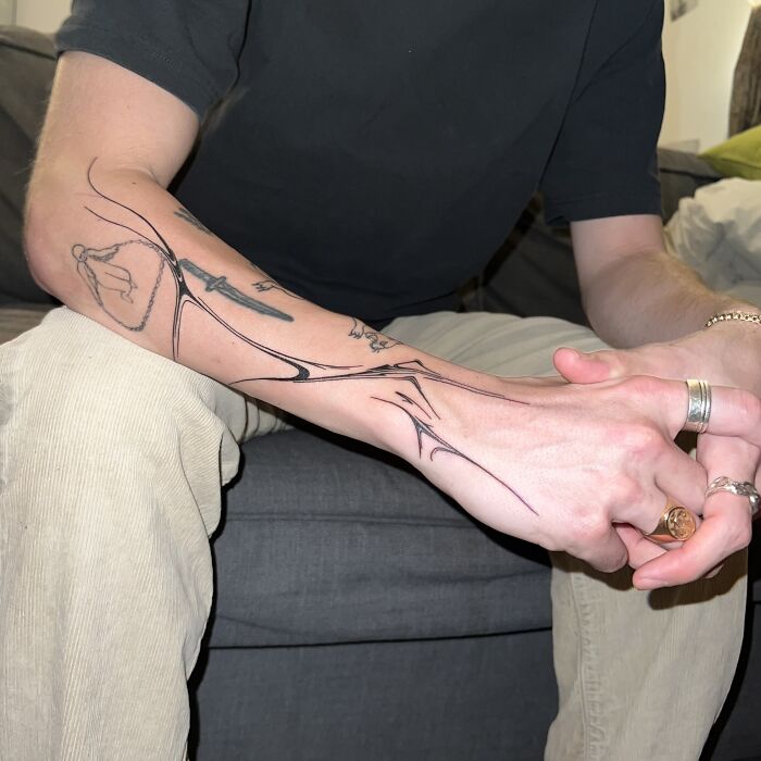 Tattoo design inspired by traditional marbling on a person's forearm, showcasing intricate and flowing patterns. Tattoo design inspired by traditional marbling on a person's forearm, showcasing intricate and flowing patterns.