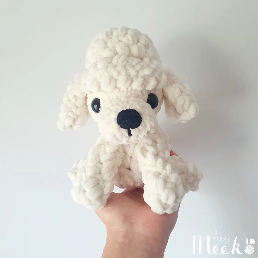 Crocheted white poodle plush toy held in hand, showcasing a cute creation from a crochet side hustle.