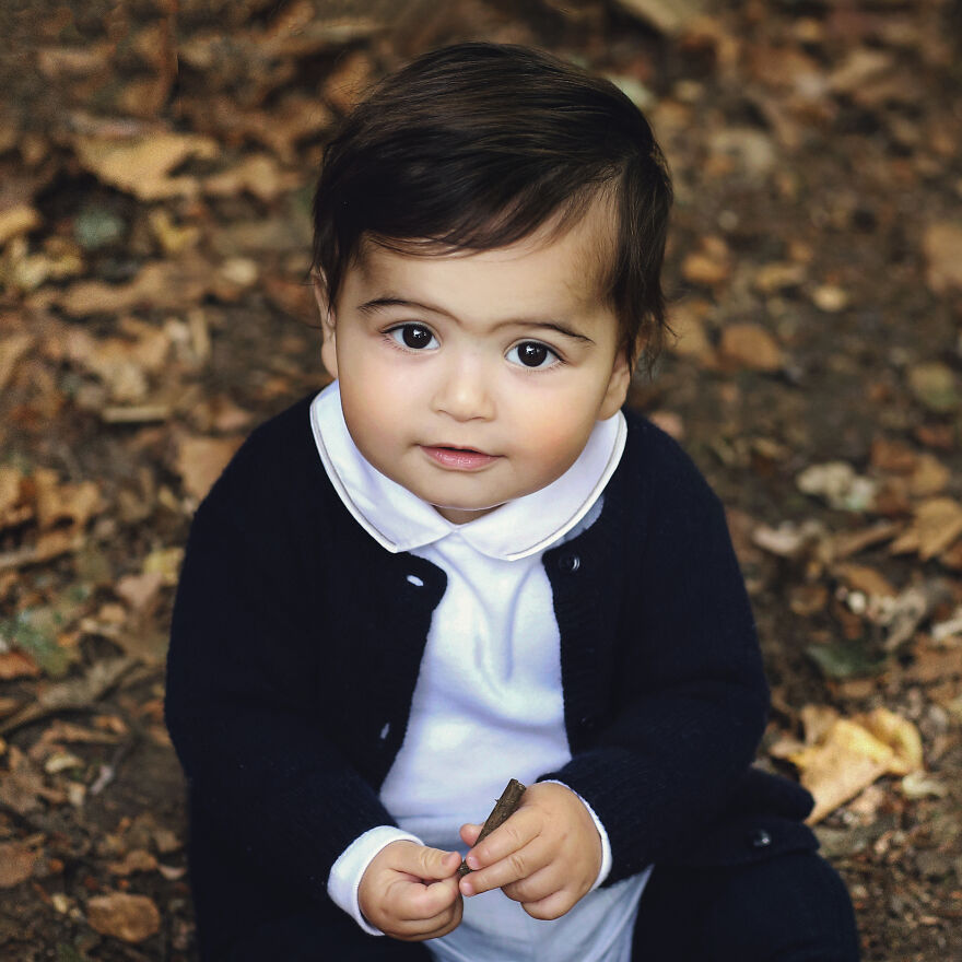 A photograph of a small boy in a park