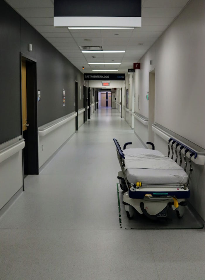 Empty hospital corridor with a medical stretcher illustrating dumbest and most expensive mistakes in healthcare settings.