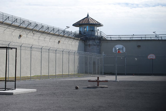 Prison yard enclosed by tall fences and watchtower, illustrating some of the dumbest and most expensive mistakes made.
