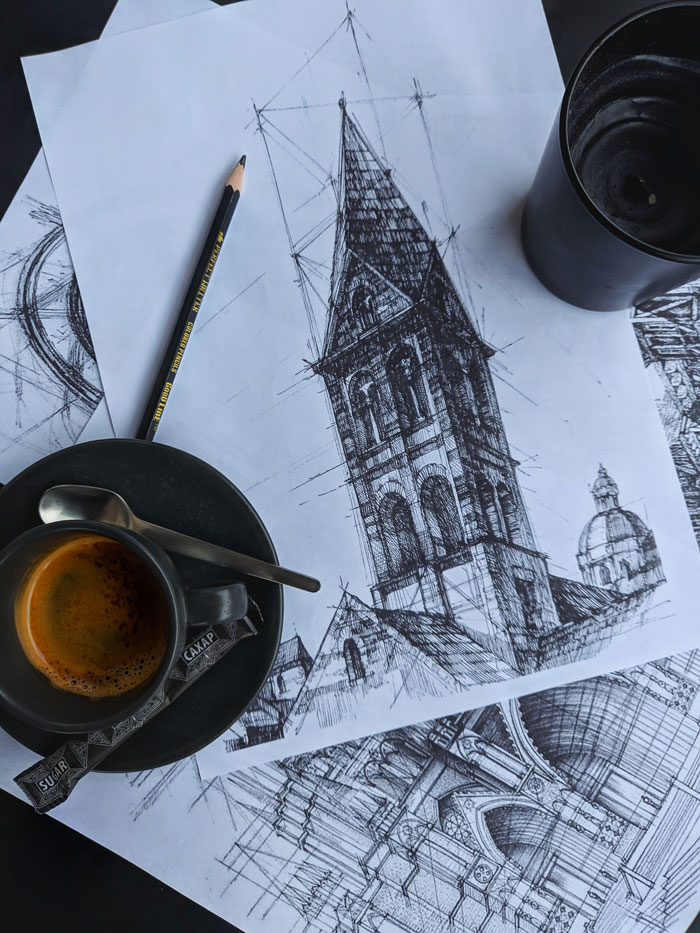 Pencil sketches of architectural drawings with a cup of coffee, illustrating drawing prompts.