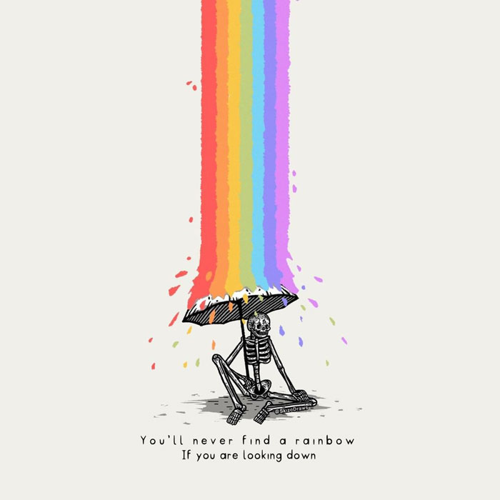 Skeleton sitting under umbrella with rainbow above, suggesting drawing prompts for creativity.