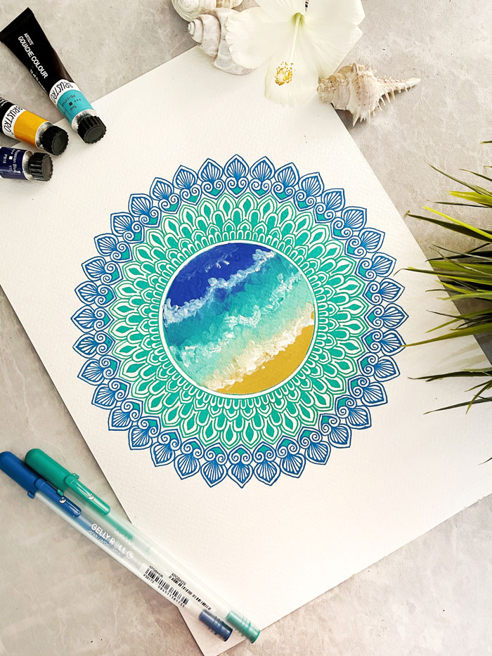 Colorful mandala drawing surrounded by art supplies, inspired by creative drawing prompts.