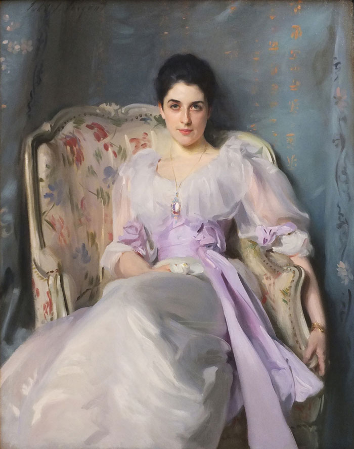 Portrait of a woman in a historical painting, dressed in a lilac gown, seated on a floral chair, with blue and gold background.