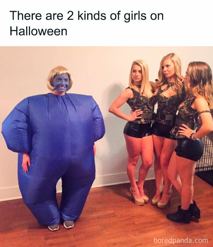 Funny Halloween contrast: one person in a blue inflatable costume, three others in matching dark outfits.