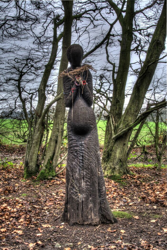 the sculpture of a woman made out of the wood