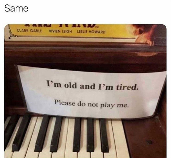 Sign on a piano reads, "I'm old and I'm tired. Please do not play me," conveying overwhelming tiredness.