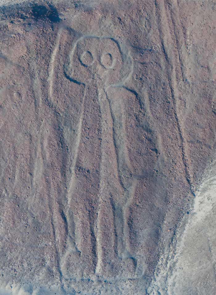 Owlman engravings on a rock 