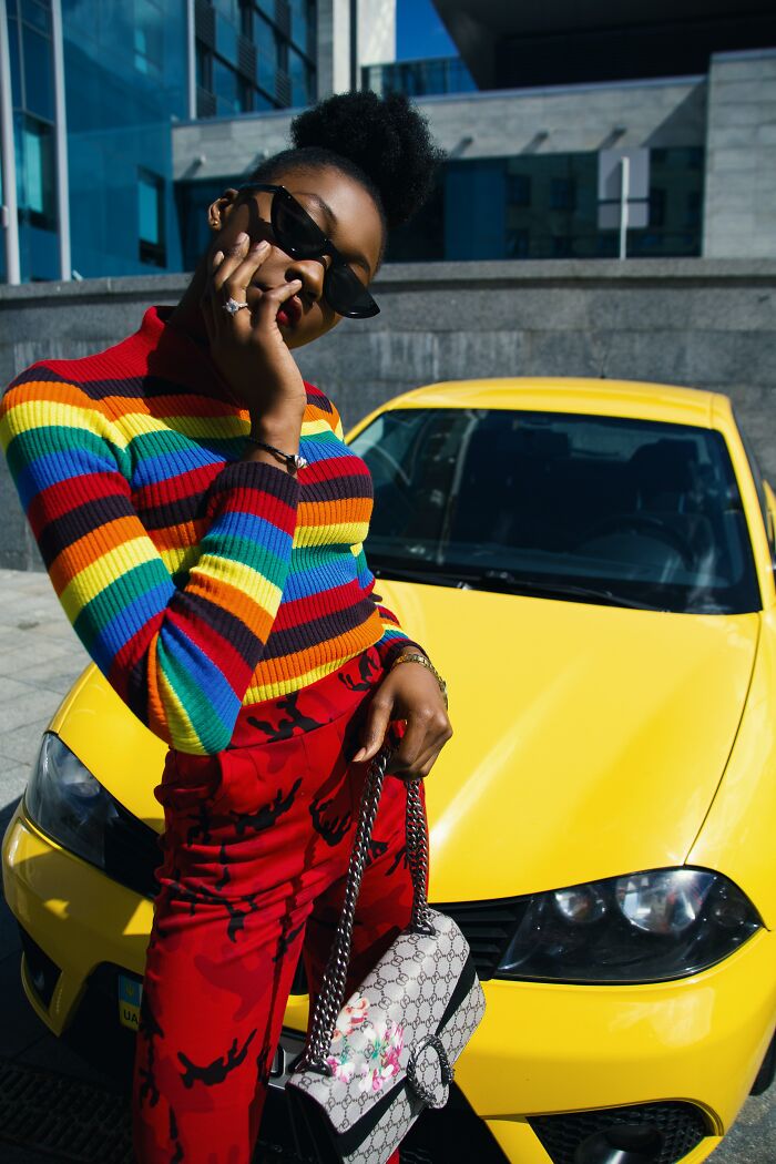 Woman Posing Next To A Yellow Car 