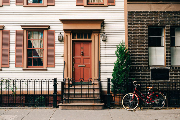 White and black houses near each other with bike