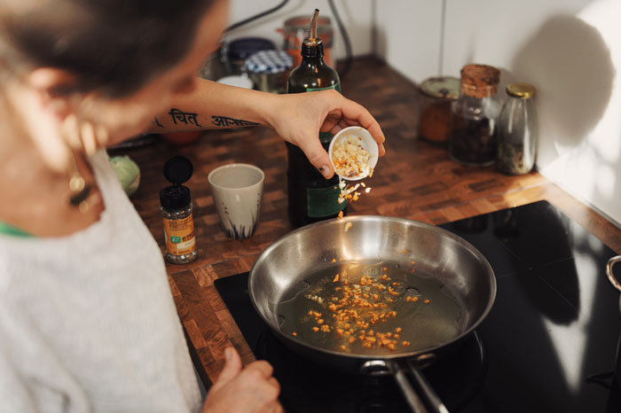 Woman cooking garlic