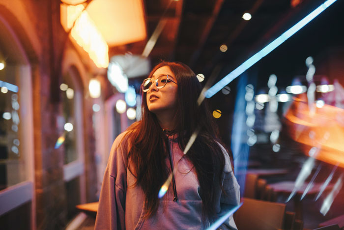 Picture of woman with glasses walking at night