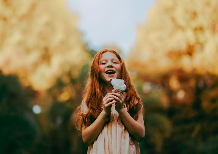 Girl looking and holding flower