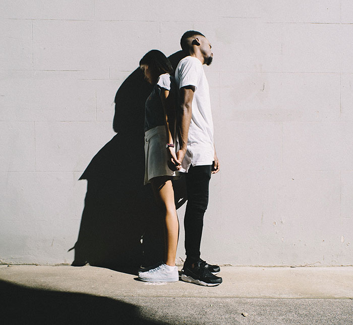 Persons holding hands and standing near each other