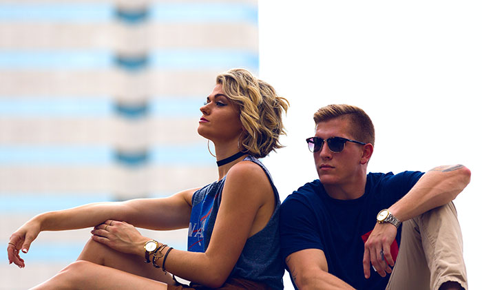 Woman and man sitting near and posing