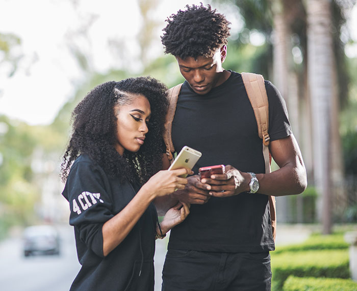 Woman and man looking at phones