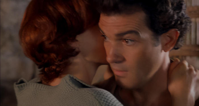 A woman whispering closely to a man showing distrust, illustrating signs of a fake friend and toxic relationship.